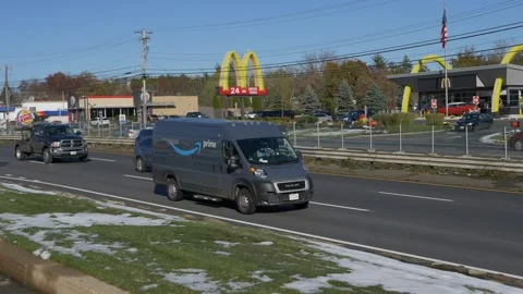 4K Amazon Prime delivery van heads down the highway 스톡 동영상 142549708
