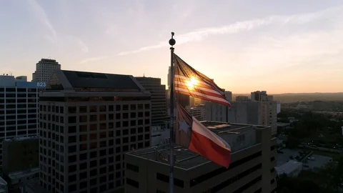 4K American Flag Flapping In Sun Austin Texas Aerial Stock Footage 97864347