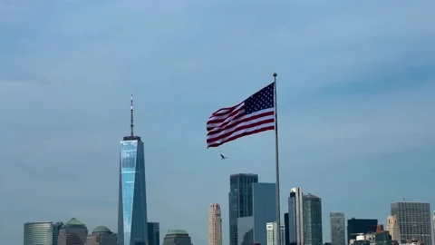 4K American Flag Flying With One World Trade Center Lower Manhattan Video stock 334450360
