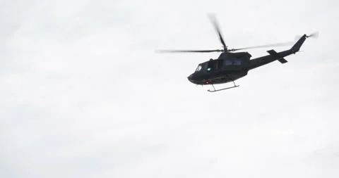4K - American UH-1 multi-role helicopter flies away Video stock 295998150
