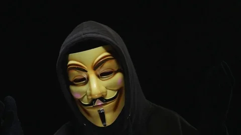 4K Anonymous Mask Man Talking  - Black Background Stockbeeldmateriaal 69796141