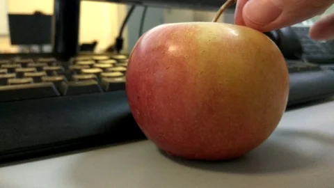 4K An apple near the computer for a diet in the office Video stock 99288442