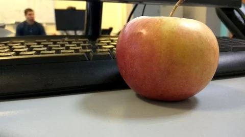 4K Apple near the computer in the office Stock-Footage 99288425