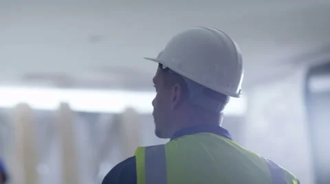4k Architect or construction worker at building site looks around the building Stock Footage 54020826