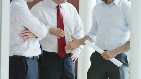 4K Architects looking at building plans &amp; having a discussion in modern office Stock Footage 68559974