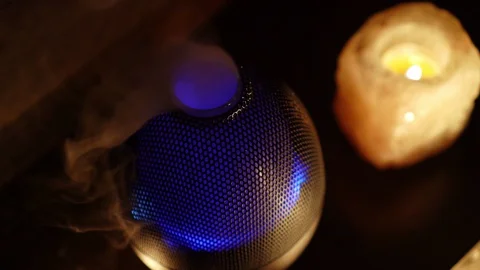 4K, Aroma electric oil diffuser lamp, candles on wooden table in room. Video stock 129297381