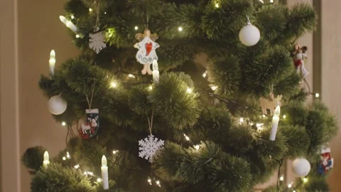 4K Artificial Green Christmas Tree With String Lights And Glowing Star Stock-Footage 334442305