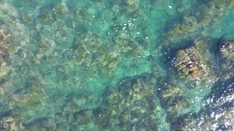 4k ascending bird eye view ocean rocky coastline with waves by drone Stock Footage 257798426