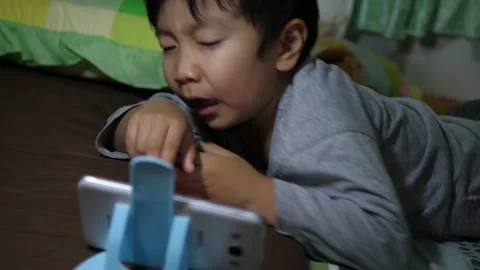 4K Asian child boy lying on bed,  sneeze from dust allergy in room. Stock Footage