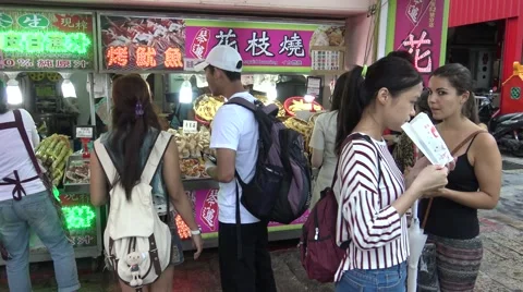 4k asian woman buy fried squid and other traditional fish food in the Street-Dan Stock Footage