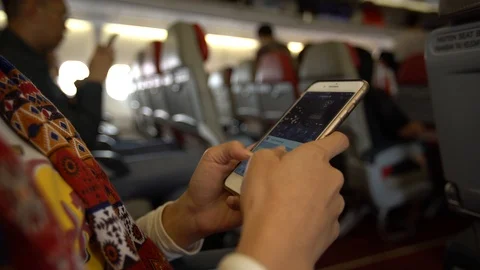 4K Asian woman using mobile phone in interior airplane. Smartphone on plane-Dan Stock Footage 89014536