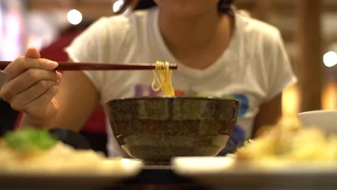4K Asian woman using sticks for eating beef noodle, restaurant Chinese food-Dan Stock Footage