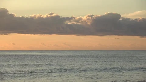 4K ASMR Charcoal-Gray Clouds between Pale Blue Sky and Warm Apricot Gradient Sky Stock Footage 345687785