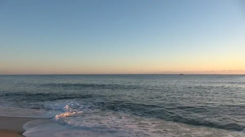 4K ASMR Deep Navy Sea under Pale Blue Sky with Thin Lavender Clouds Stock Footage 345175960