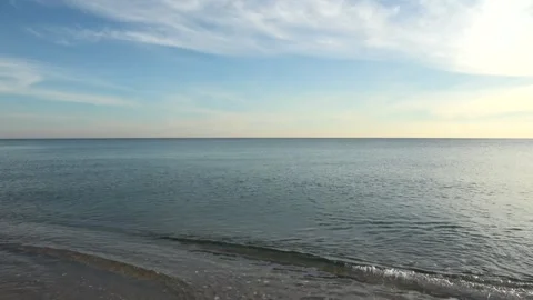 4K ASMR Deep Teal Sea under Pastel Blue Sky with Cream Ivory Feather Clouds Stock Footage 340928474