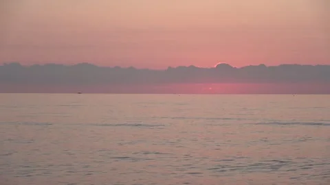 4K ASMR Emerging Platinum Sun above Sepia Sea Horizon under Rose Pink Sky Stock Footage 341758317