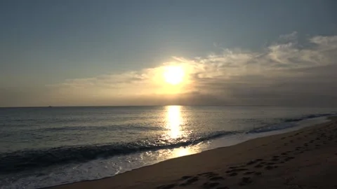 4K ASMR Footprints on Gray-Brown Beach under Dusty-Blue Sky with Apricot Clouds Stock Footage 345616269