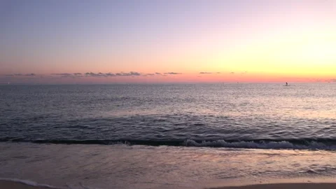 4K ASMR Paddleboarding Silhouette on Deep Slate-Blue Sea under Lavender-Blue Sky Stock Footage 345687905
