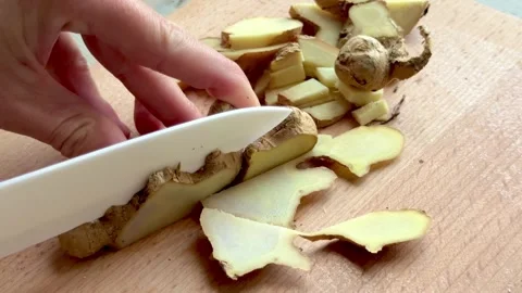 4K ASMR video of cutting fresh healthy piece of ginger Stock Footage 319473481