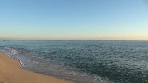 4K ASMR Warm Brown Wet Shore and Deep Blue Sea under Pale Blue Sky Stock Footage 345687855