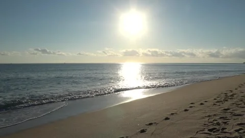 4K ASMR White Sun with Pale Yellow Rays across Pale Blue Sky over Slate-Blue Sea Stock Footage 345687902
