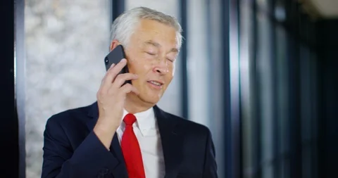 4K Assertive senior businessman dealing seriously with a problem over the phone Stock Footage 101416295