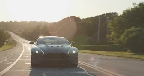 4K Aston Martin Sports Car Driving Down Empty Highway Stock Footage