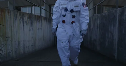 4K Astronaut on an exploration trip, walking away from mission control building. Stock Footage