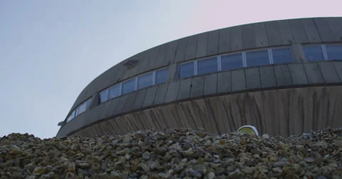 4K Astronaut looking for signs of life outside mission control building Stock Footage