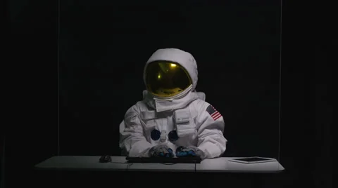4K Astronaut sitting at desk, using computer with interactive touch screen Stock Footage 64094345