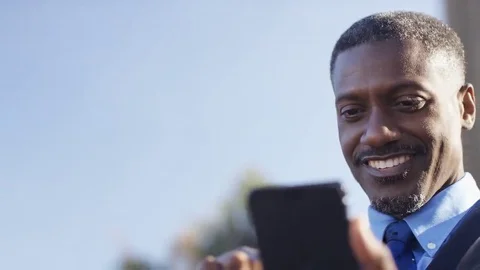 4K Attractive business man using his phone outdoors, in slow motion Stock Footage 69232944
