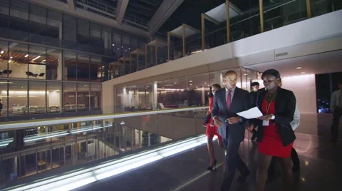 4K Attractive diverse business group walking thru large modern office building Stock Footage