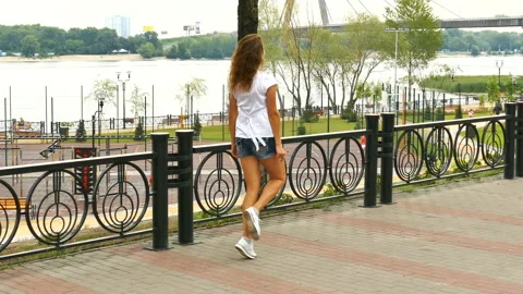      4K. Аttractive girl does dancing figures on city street. Bright emotions ,  Stockbeeldmateriaal 94954592
