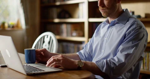  4k Attractive man sitting and working on his computer in the office Stock Footage 128365211