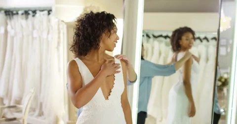 4k, An attractive young bride being helped into her wedding dress. Stock Footage 74222620