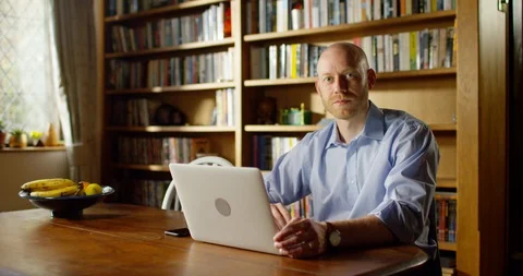 4k An attractive young man working from home on his laptop Stock Footage 128361356