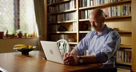 4k An attractive young man working from home on his laptop Stock Footage 128362638