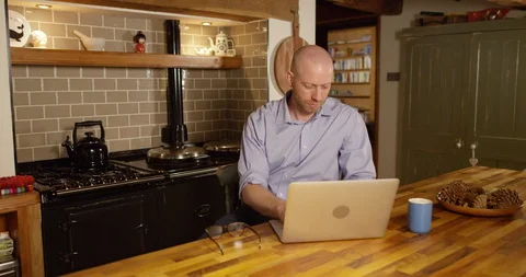 4k An attractive young man working from home on his laptop Stock Footage 128375681