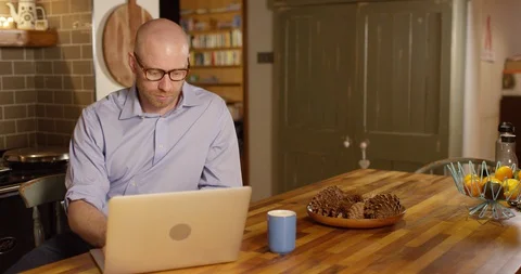 4k An attractive young man working from home on his laptop Stock Footage 128381300