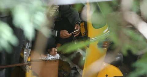 4K-auto-rickshaw-driver-checking-mobile-phone Stock Footage 141171318