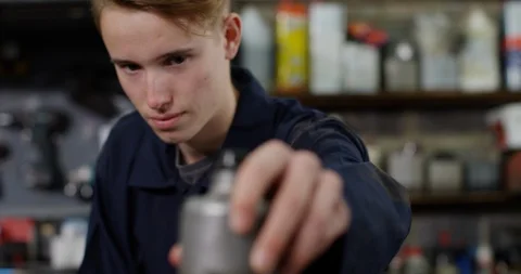 4K Awkward apprentice mechanic messing up in garage workshop Stock Footage 112270727