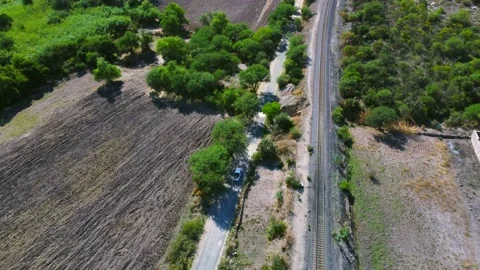 4K B-roll: Car driving into trees on a country road Video stock 201203199