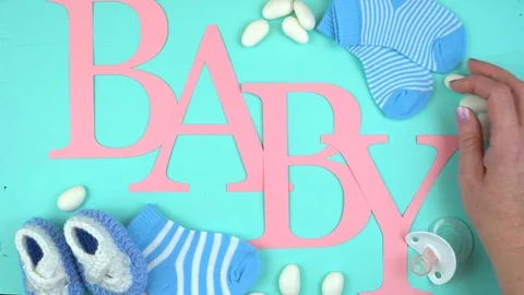 4k Baby nursery clothing and accessories overhead with letters spelling the w Stock Footage