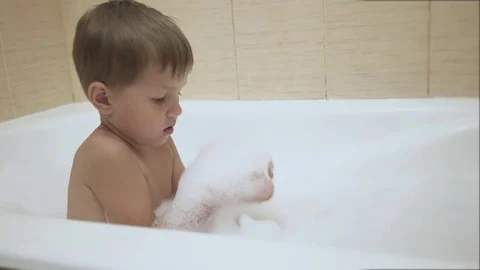 4K. Baby plays with bubbles while taking a bath Stock Footage 77259775