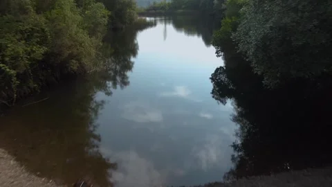 4k back drone shot of a lake Revealing a Girl in a White Dress Stock Footage 282443985