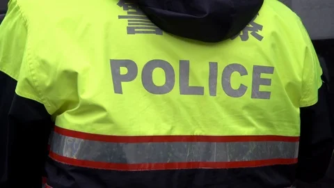 4K, back of policeman officer's jacket with the word police. Patrolling city-Dan Stock Footage 91800858