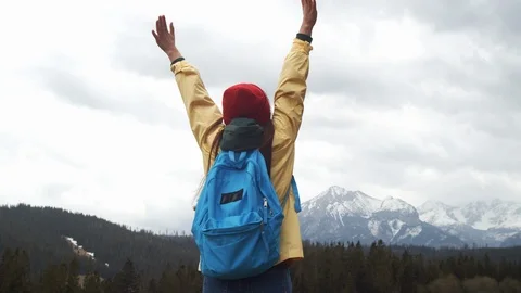 4k back view portrait of happy girl holding arms above head enjoying time Stock Footage 107520074