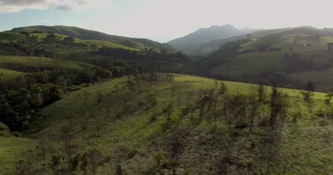 4k Backlit aerial shot tracking over lush green hills #4 Vidéo 238553735