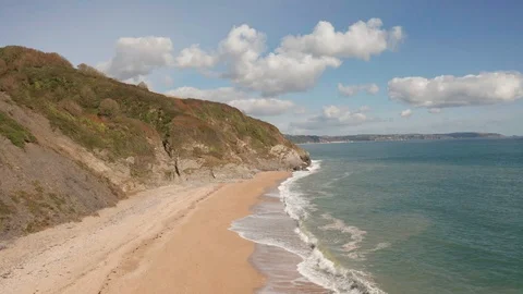 4K Backwards Ascending Flight Along Beach on the South Devon Coast Stock Footage 117055351