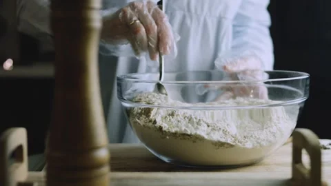 4K Baker Adding Aromatic Spice to Flour at the Worktable Stock Footage 342113348